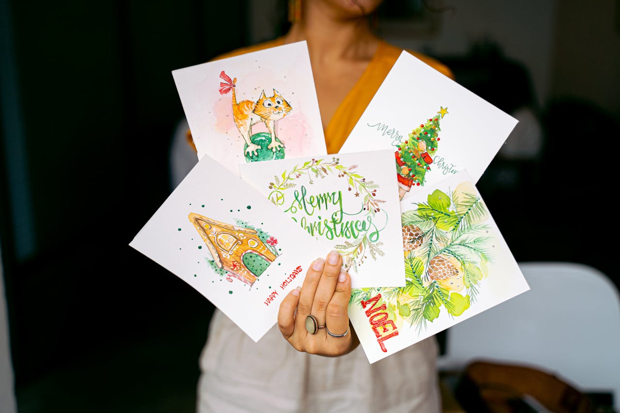 Person holding festive Christmas cards created with Simple Heart
